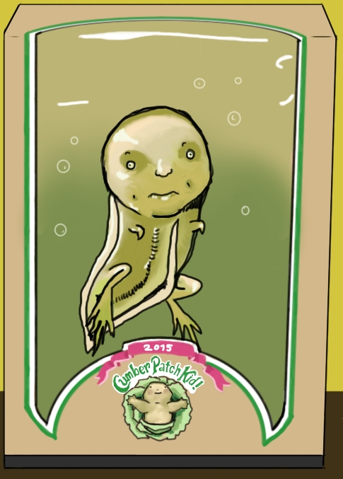 In a container that looks like a Cabbage Patch Kid belongs inside (complete with a parody of the logo that says Cumber Patch Kid 2015), there is a little tadpole looking creature inside.