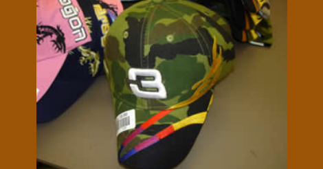 Photo of a camouflaged cap with a number 3 on it.